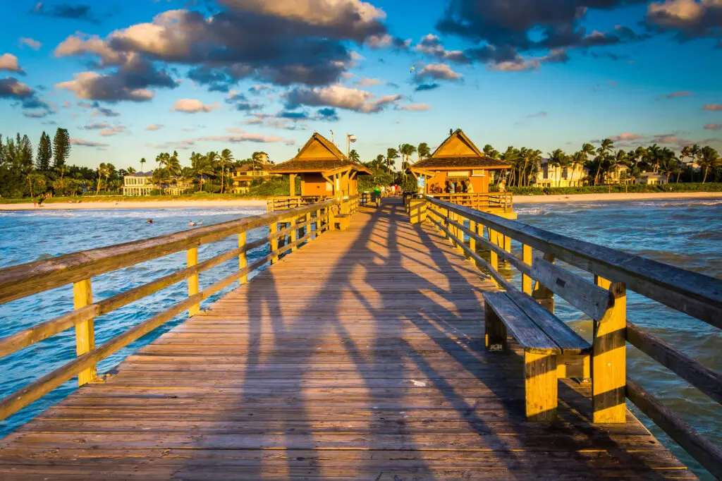 Wooden pier stretching out into the Gulf of Mexico at Marco Island, capturing coastal charm and relaxed luxury—one of the best coastal places to live in Florida.